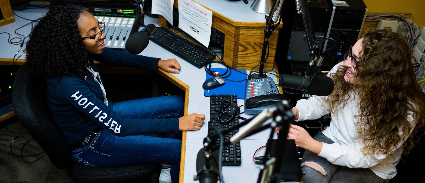 Two students talking on air in the WXOU radio station